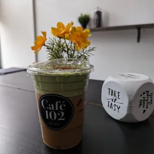 a cup of coffee and a clock on a table