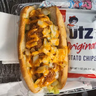 Catfish sub with fried onions, lettuce and tomatoes... Chips come with it