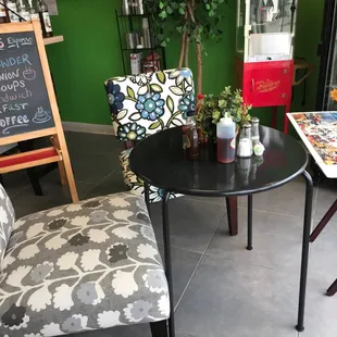 Specials menu, table with padded chairs, cold case, puzzle in progress