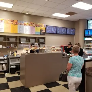 a woman ordering food at a counter