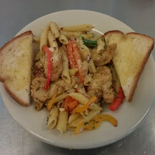 a plate of pasta with chicken and vegetables