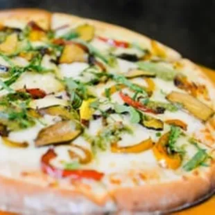 a pizza with vegetables and cheese