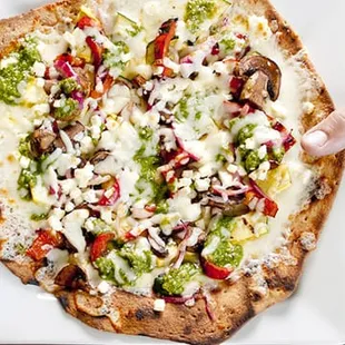 two hands reaching for a pizza