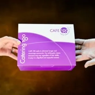 two hands holding a box of coffee