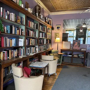 a view of a library with chairs and bookshelves