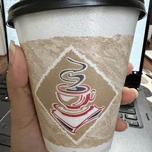 a hand holding a cup of coffee
