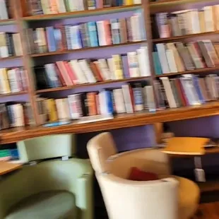 two chairs in front of a bookshelf