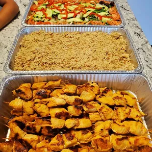 Chicken kabobs, pilaf rice, and fresh garden salad