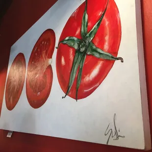 a painting of a tomato on the wall