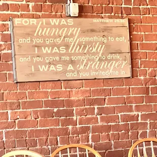 a brick wall with a sign on it