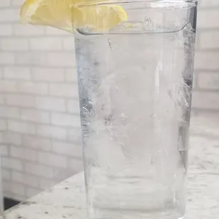 a glass of water with a slice of lemon