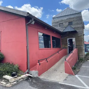 a man standing in front of a red building