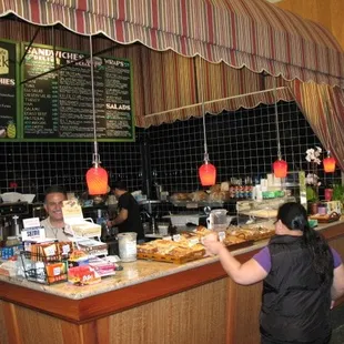 a woman ordering food at a counter