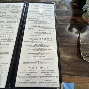 a menu and a person holding a donut