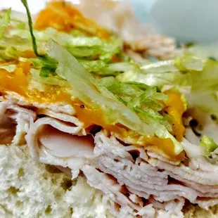 a closeup of a sandwich with lettuce and turkey