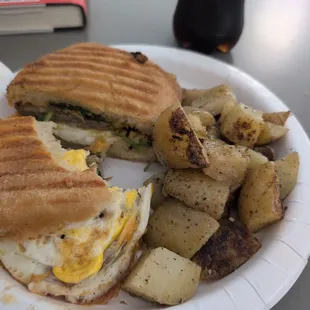 Breakfast panini with sausage, cheddar, spinach, and tomato.
