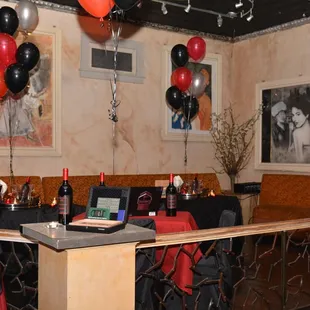 a bar with balloons and wine bottles