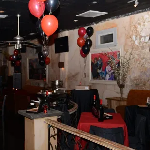 a bar with balloons and wine bottles