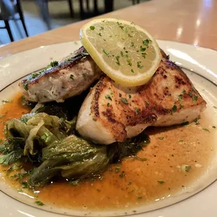 Pan seared sword fish over greens