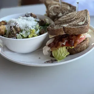 a plate with a sandwich and a bowl of salad