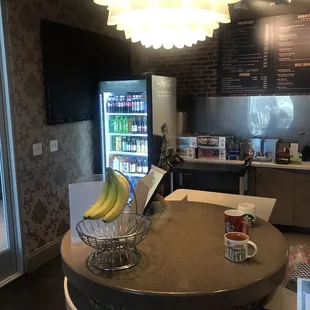 a counter with a bowl of bananas on it