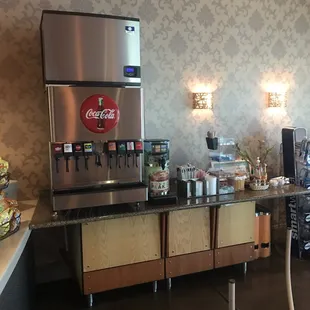 a coffee bar with a beverage dispenser