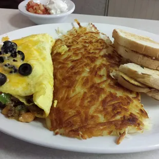 Taco omlette.  Hashbrowns and sourdough toast.  Came with a side of salsa and sour cream.