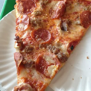 a slice of pepperoni pizza on a paper plate