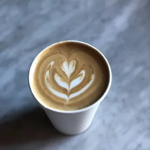 a cup of coffee with a latte art
