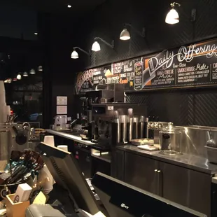 a coffee shop with a menu on the wall