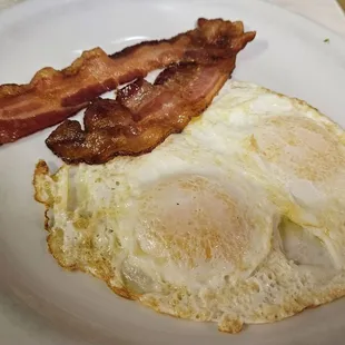 fried eggs and bacon on a plate