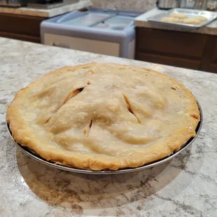 a pie in a pie pan on a kitchen counter