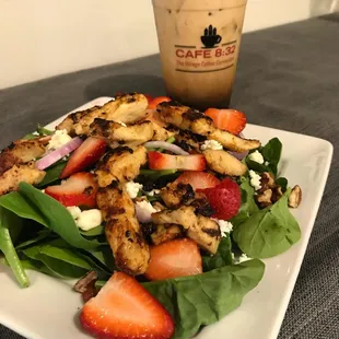 a salad with strawberries and chicken