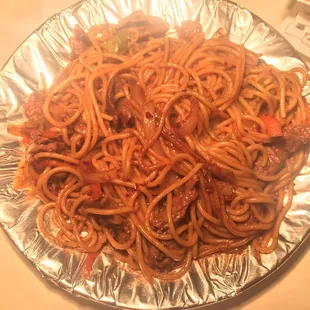 a plate of spaghetti with meat and vegetables