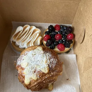Lemon meringue tart, berry custard tart, almond chocolate croissant
