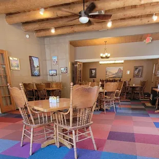 One of the indoor dining spaces which is decorated with art work for sale