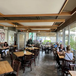 people sitting at tables in a restaurant