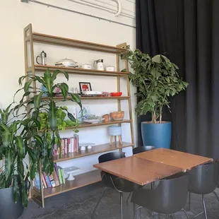 a table and chairs in front of a bookcase