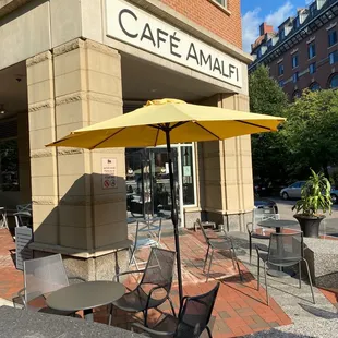 tables and chairs in front of a cafe amalfi