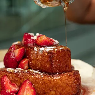 Tres Leches French Toast: Brioche, Tres Leches Custard, Cinnamon, Rum Dulce de Leche, Gold Flakes, Whipped Cream &amp; Strawberries