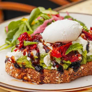 Avocado Burrata Toast, with Sundried Tomatoes and Dressing.