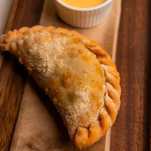 Empanadas: Pollo Verde Pot Pie, Black Bean Queso Fundido. Served with Aji Sauce &amp; Chimichurri Crema