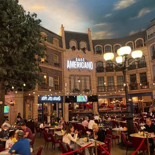 people sitting at tables in a restaurant