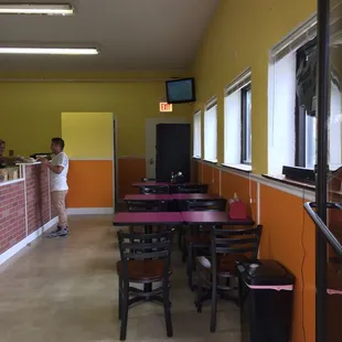 a man standing in the doorway of a restaurant