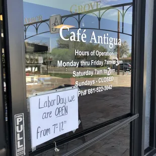 a sign in the window of a cafe