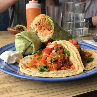 a plate of tacos and a glass of water