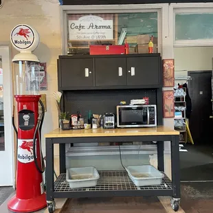 a red gas pump and a counter