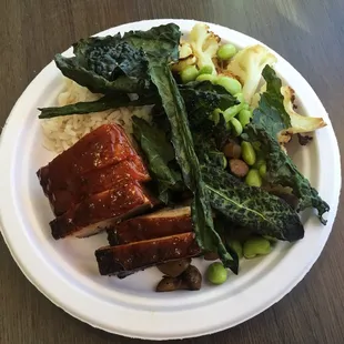 Pork belly with gochujang sauce, rice, cauliflower, mushroom, edamame, and kale chips