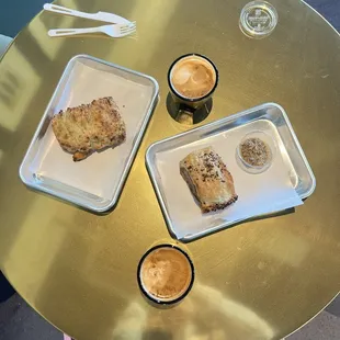 Cheddar chive biscuit, two Cortados, and a sausage roll