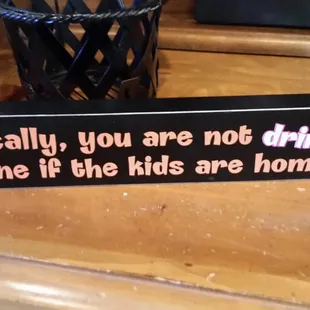 a sign that says technically, you are not drinking alone if the kids are home